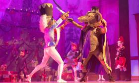 The Nutcracker and the Mouse King fight with swords on stage in the Nutcracker