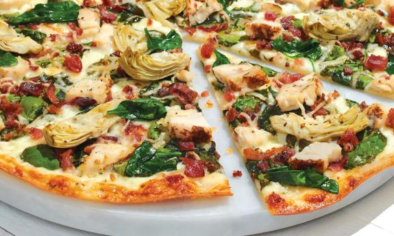 A pan of the chicken bacon artichoke pizza