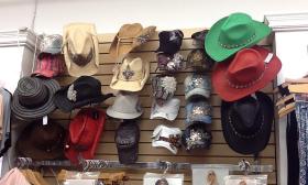 Various hats hanging on a wall display