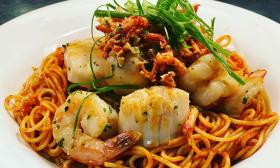 A seafood pasta dish with garnishes on top