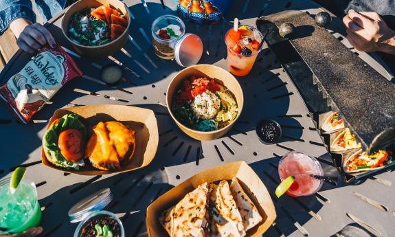 An assortment of food and beverages laid out on the table