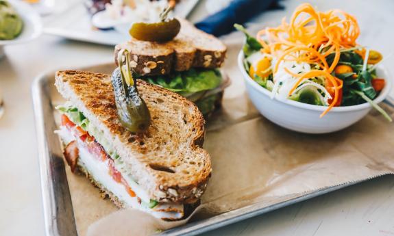 A plated sandwich and a side salad