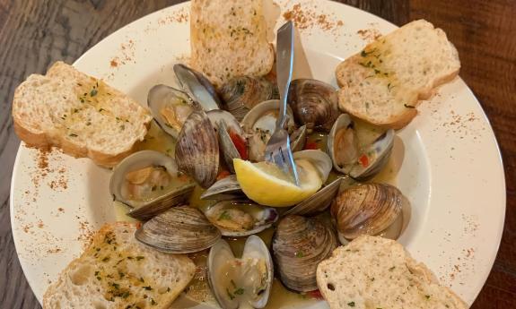 A seafood meal with seasoned bread bordering the plate