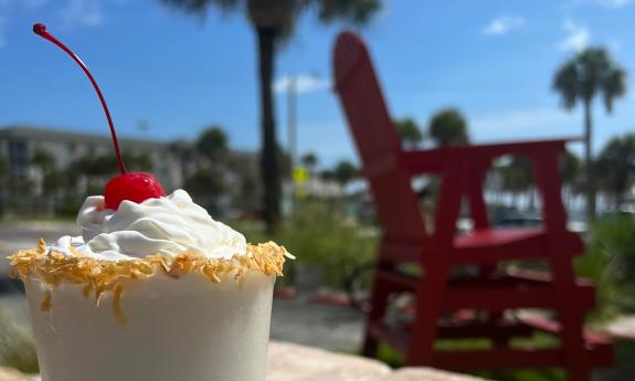 The Banana Bread Colada at Crabby's Beachside, is made with Banana Bread Rum, Kahula, and house-made piña colada mix