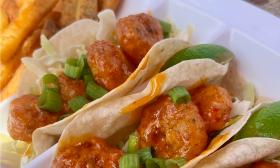 An order of Crabby's Boom Boom shrimp tacos features three tacos stuff with shrimp on cabbage and cilantro