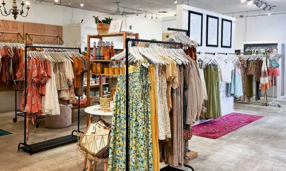 Clothing pieces organized and displayed on racks