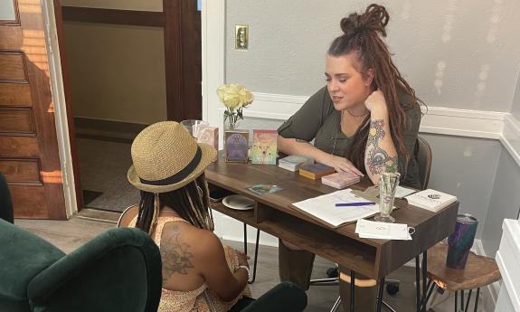 A guest getting a tarot card reading at the Hopcraft Collective