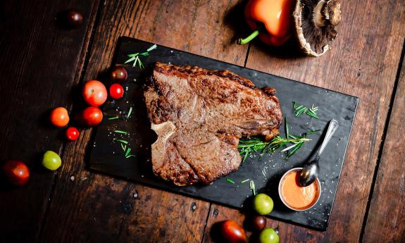 A piece of steak laid out on a board