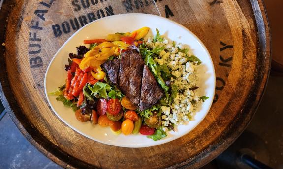 A steak salad decorated with additional toppings