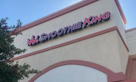 The Smoothie King sign outside the building