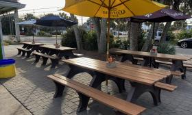 The outside seating area with shaded picnic tables