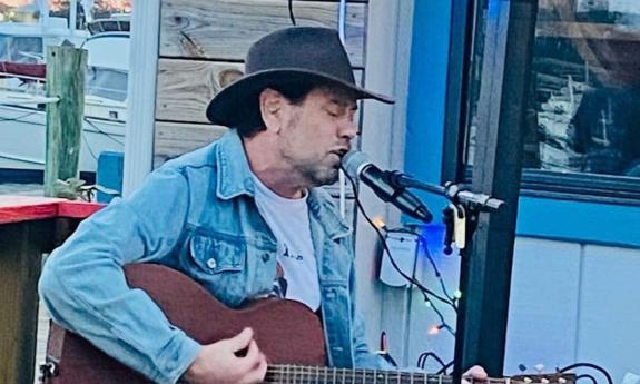 Musician Allen Arena with guitar performing solo