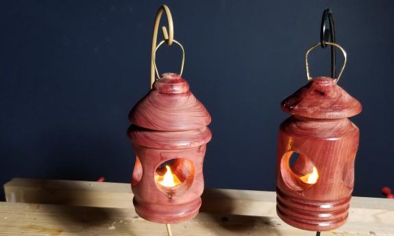 A unique Christmas ornament with a tea light sitting in the inside of it