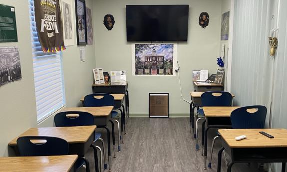 This classroom, used for genealogy classes has a video screen and geneaological charts on the walls