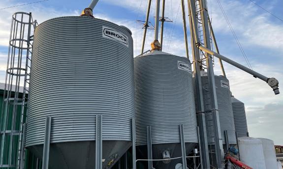 Silos with animal feed against a blue sky with light clouds