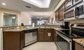 A brown and beige kitchen with stainless steel appliances