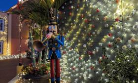 A colorful full-size holiday band member stands sentry at the Hilton during Nights of Lights
