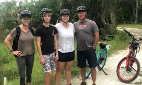 A family from Boston pause while riding their rental bikes from Island Bikes on the GTMNR trails