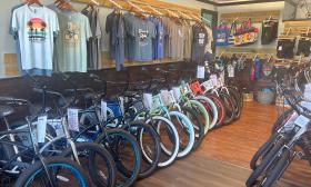 A section of the Island Life Bikes shop shows bikes, t-shirts, and gear for the trail