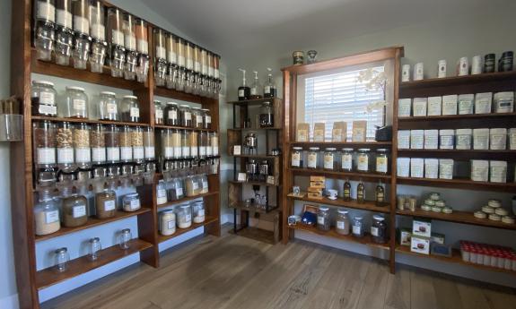 Shelves and containers filled with an assortment of nuts and grounds