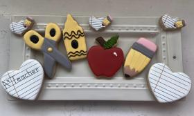 A back to school cookie set with an apple, pencil, scissors, crayon, and notebook paper scheme