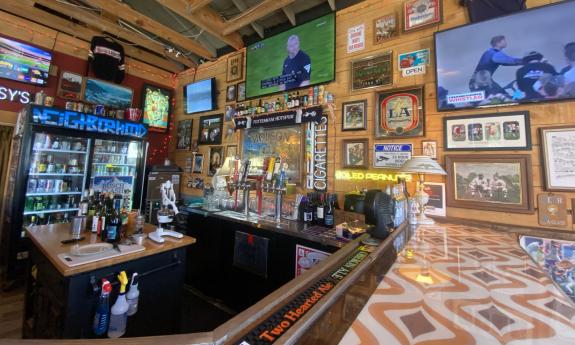 TVs are set up above the bar section of the establishment