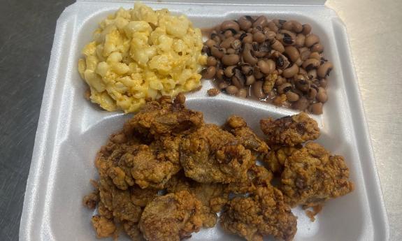 A chicken liver dinner in a to-go container