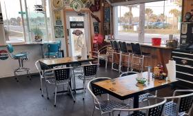 The inside dining area with retro car decor surrounding the space