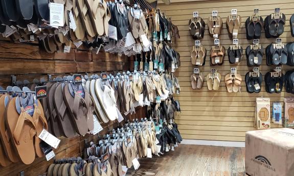 Rainbow sandals/flip flops hanging on the wall 