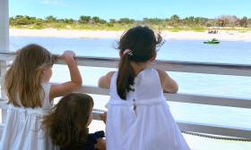 Three young girls gaze at Vilano Beach while on a Red Boat Tour