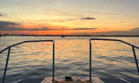 The sunset off the stern of the boat operated by River Lion Excursions