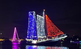The Schooner Freedom decorated in red, white, and blue, lights, with stars along the rail