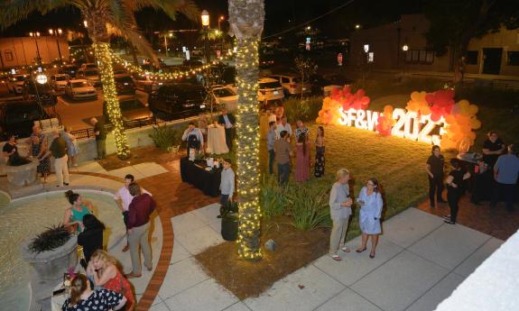 The Radzinski Garden at the Lightner during an event for the Spanish Food and Wine Festival, with a brightly-lit sign 