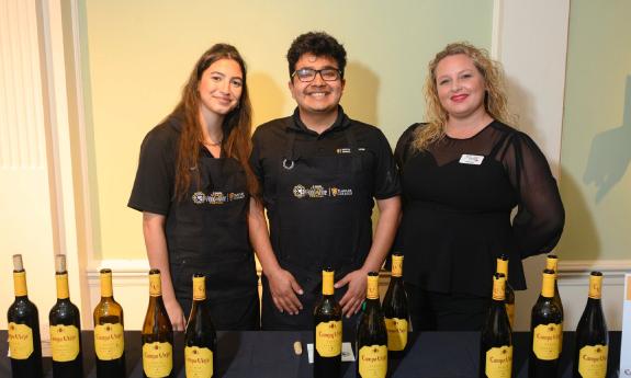 Three people prepared to serve tastings of wine at the Spanish Food and Wine Festival