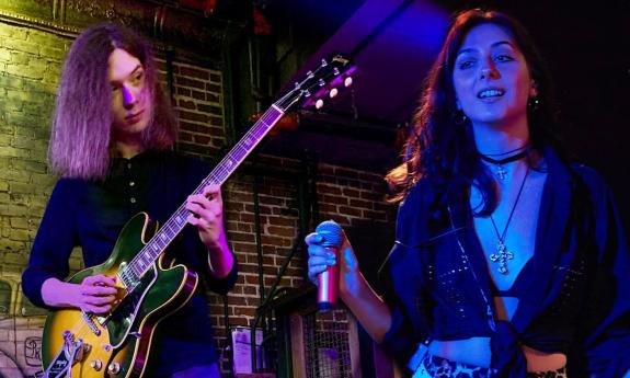 The duo Lauren and Evan onstage with guitar and microphone, at TradeWinds Lounge in St. Augustine, Florida