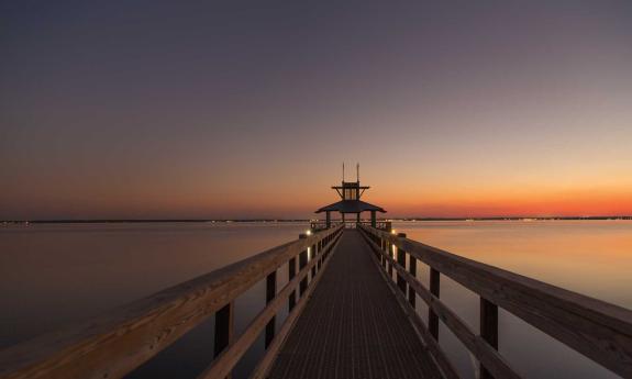 RiverTown community pier extending into the horizon at sunset