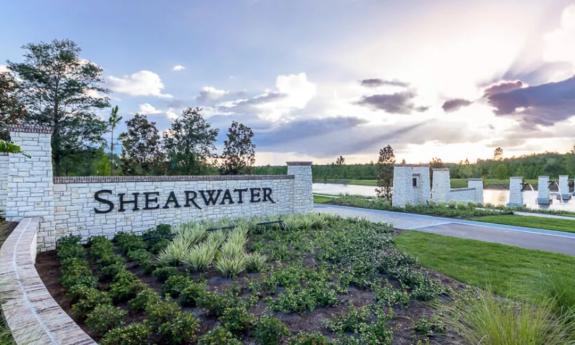 The entrance to the Shearwater community with landscaped grounds and a stone sign