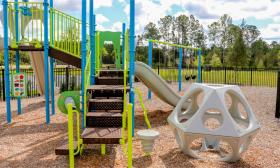 A playground with wood chip covering at St. Augustine Lakes community