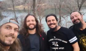 The band Vern Daysel and Burnign Breeze, on a hillside overlooking a lake