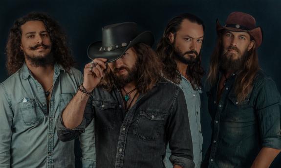 The band Vern Daysel and The Burning Breeze standing together