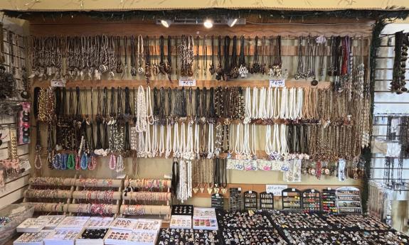 Various necklaces, bracelets, and rings presented on the table and wall