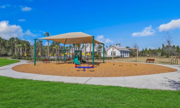 A covered playground area with slides and swings for kids to enjoy