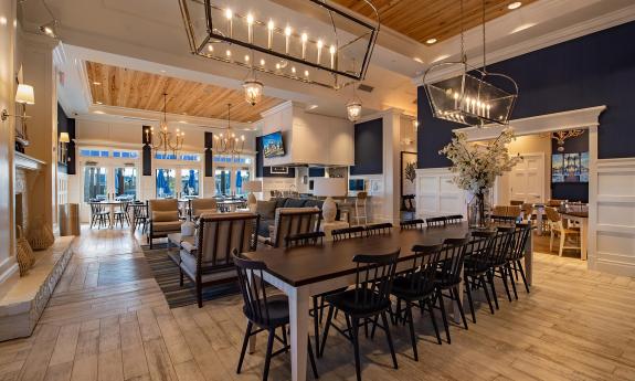 The interior of the clubhouse with tables and chairs taking up the available space