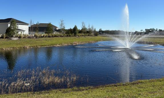 A pond sits inside this modern living community