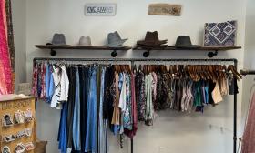 A clothes rack with an array of hats sitting on top