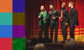 The four members of On Pont a Capella stand on stage harmonizing