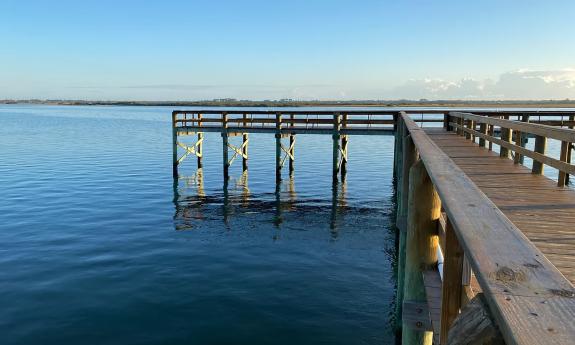 A long pier stretches out over the lake for residents to use