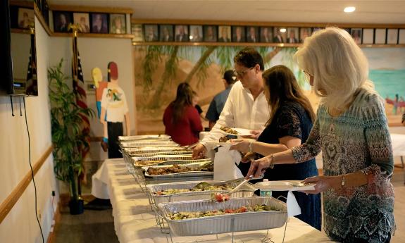 Guests at a dinner buffet at St. Augustine Shrine Club