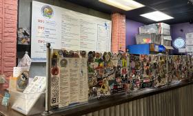 The menu is displayed on the wall behind the counter