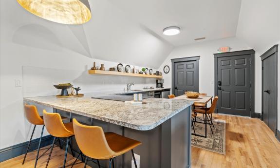 Kitchen and dining area in Apartment three has both a table and counter seating